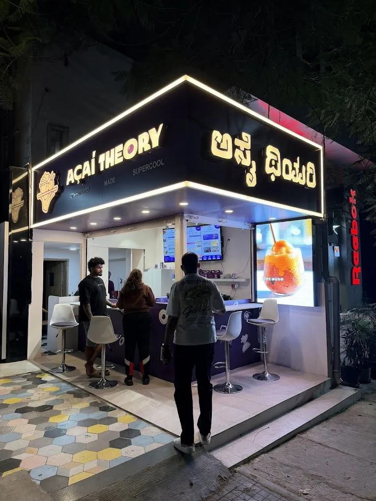 Açaí Theory storefront in Indiranagar at night with an outdoor LED wall beside the counter