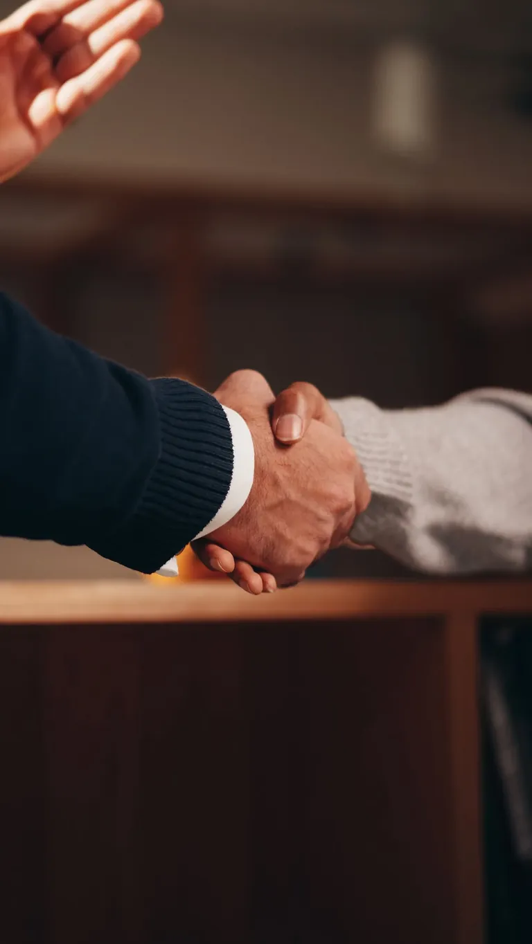 Two people shaking hands on a deal